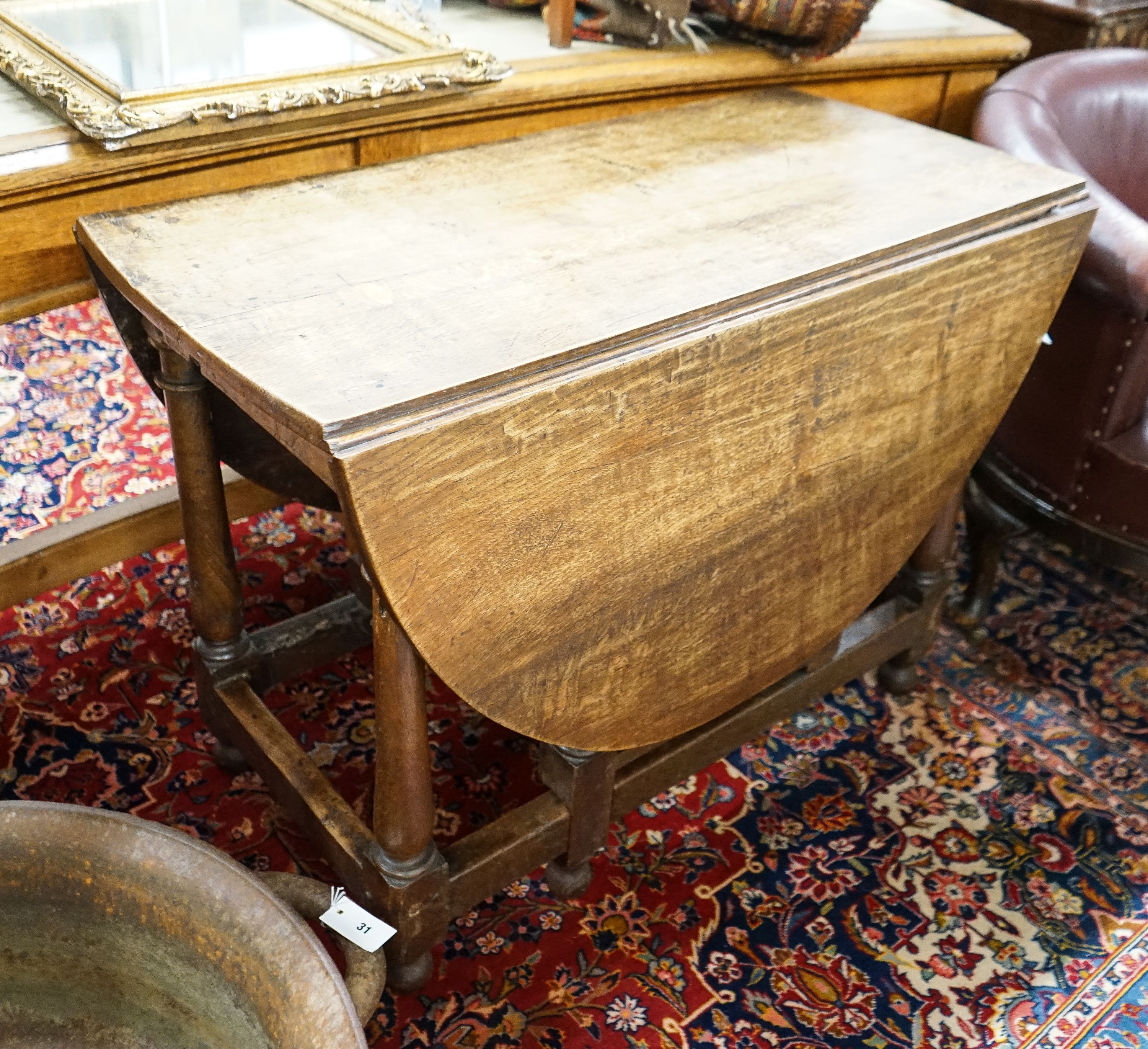 An 18th century style oak gateleg dining table, length 148cm extended, width 105cm, height 76cm